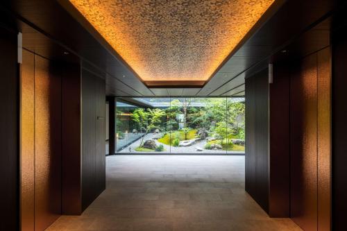 an empty hallway with a large window in a building at Hilton Kyoto in Kyoto