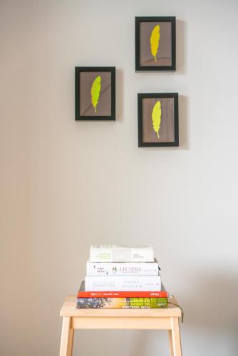 a table with a stack of books and pictures on the wall at Top 3 Alpe Maritima - Seetraum in Annenheim