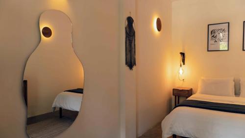 a hotel room with a bed and a curved wall at La Veranda Hotel & Restaurant in Minca