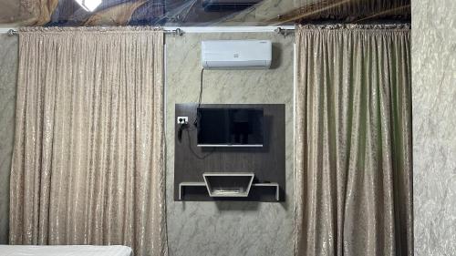 an overhead view of a room with a tv and curtains at Sultan hotel boutique in Andizhan