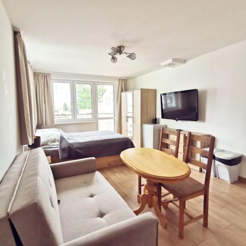 a living room with a couch and a table at Villa Krysia 50 m do morza in Międzyzdroje