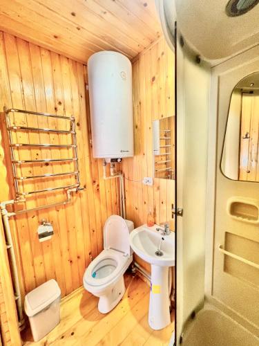 a small bathroom with a toilet and a sink at Хатинка in Yaremche