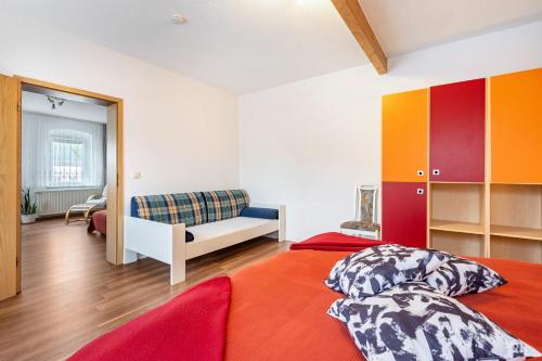 a bedroom with a bed and a couch at Ferienwohnung Familie Köhler in Thalheim