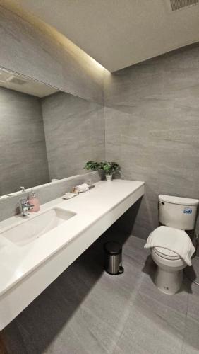 a bathroom with a white sink and a toilet at Zenery Lake Resort in Ban Don Klang
