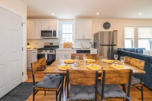 a kitchen with a wooden table with chairs and a dining room at 30-3 - 3BR Boston - Cozy Apt near Franklin Park Zoo in Boston