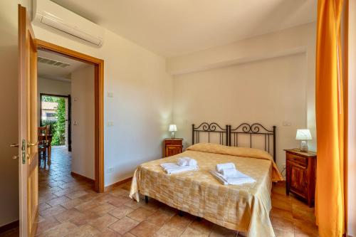 a bedroom with a bed with two towels on it at Residence surrounded by greenery with swimming pool in Sorano in Sorano