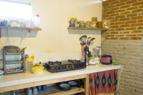 a kitchen with a stove on a counter top at Stay Together in Tetebatu