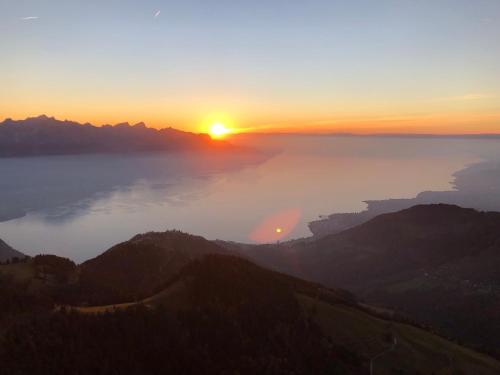 a view of the sun setting over the ocean at Les Dents-du-Midi in Monthey