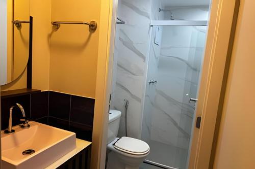 a bathroom with a shower and a toilet and a sink at Airfamily Congonhas in Sao Paulo