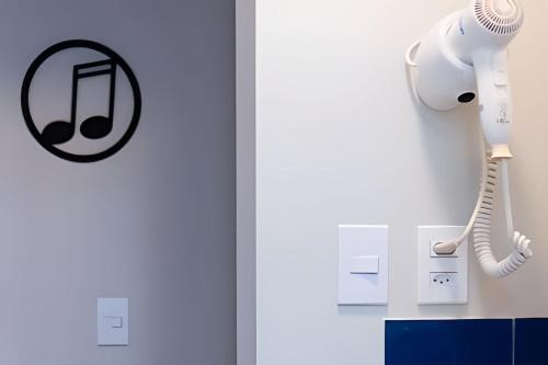 a room with a phone hanging on the wall at Airfamily Congonhas in Sao Paulo