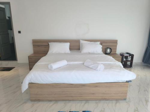 a large bed with two white pillows on it at Trinco Caritas Guest Villa in Trincomalee