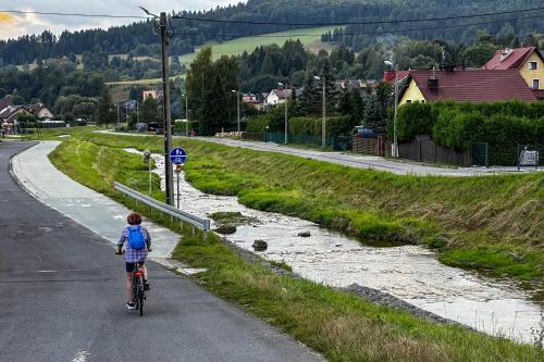 a young child riding a bike down a road at Piastun SPA&Wellness Krynica-Zdrój in Krynica Zdrój