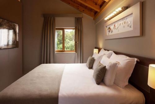 a bedroom with a large bed with white pillows at Palace Natali in Dubrovnik
