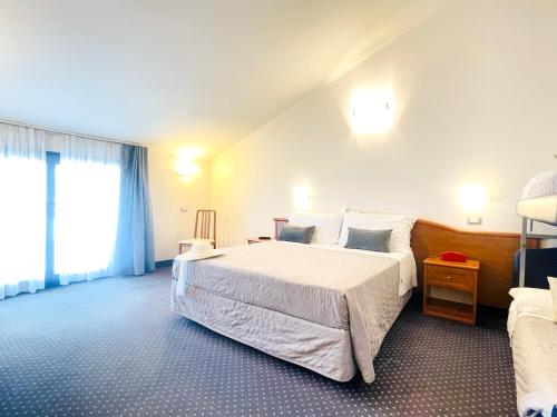 Postel nebo postele na pokoji v ubytování Hotel Bolognese