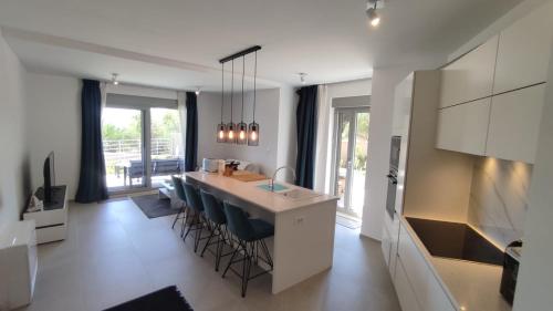 a kitchen with a counter and a island with chairs at Zavala Residence in Zavala
