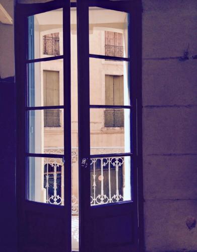 an open window of a building with a balcony at Féria Lodge in Béziers
