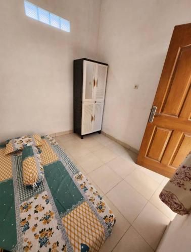 a room with a door and a bed in a room at Lourdes Blessing Hills in Tomohon