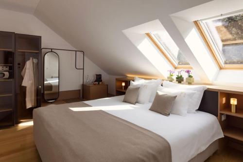 a bedroom with a large bed with white pillows at Palace Natali in Dubrovnik