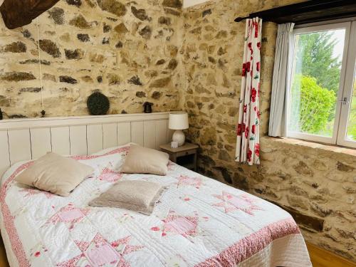 a bedroom with a bed and a window at Maison Du Silence in Saint-Maurice-près-Pionsat