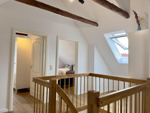 a staircase leading to a living room with a skylight at Friesenhus - Jever in Jever