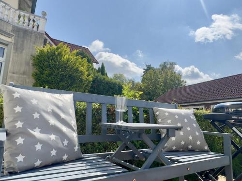 a blue bench with two pillows and a table at Friesenhus - Jever in Jever