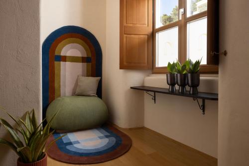 a room with a rainbow chair and a window at Palace Natali in Dubrovnik