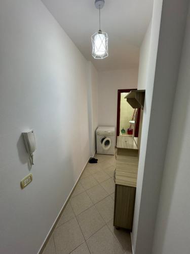 a hallway with a bathroom with a toilet and a phone at Ridi Apartament's in Vlorë