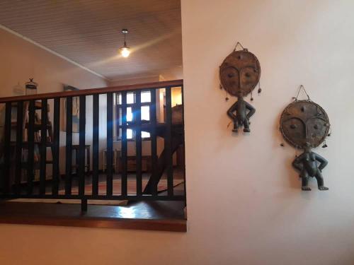a room with a staircase and a wall with two ironicans at Boulevard Inn Mt Meru in Arusha