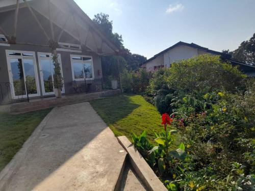 a house with a garden and a pathway at Boulevard Inn Mt Meru in Arusha
