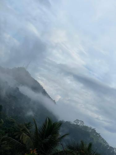 a view of a mountain with clouds in the sky at Namaya Nature in Kandy