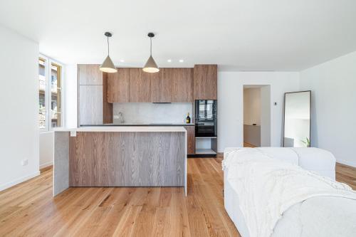 Il comprend une cuisine ouverte et un salon doté d'un canapé blanc. dans l'établissement Appartement d'architecte Port de Nice, à Nice