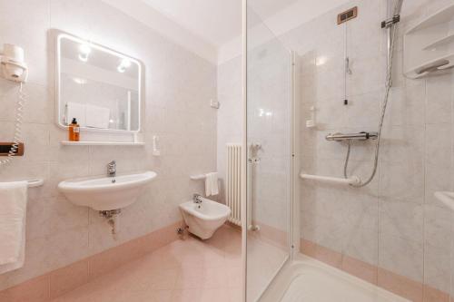 a bathroom with a shower and a sink and a toilet at Hotel Vioz in Peio Fonti