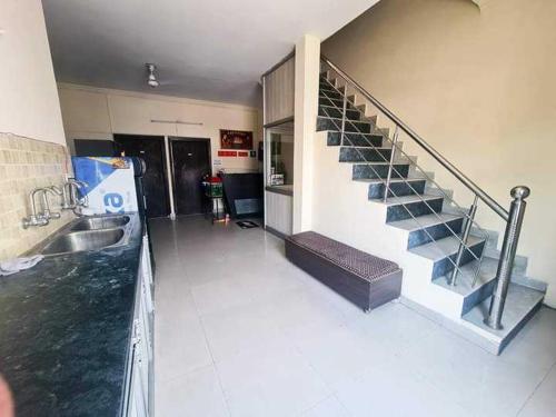 a room with a staircase and a sink in a building at Hotel O Prince Paradise in Amritsar