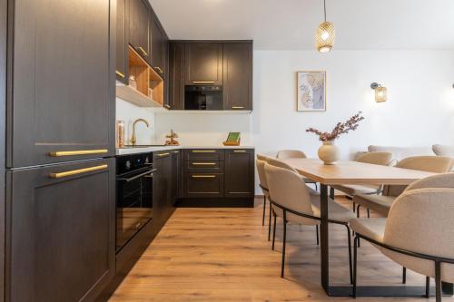 a kitchen and dining room with a table and chairs at Lush Suites in Trogir