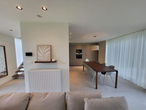 a living room with a couch and a table at Vakantiewoning 'Tranquille' Kortenaken in Kortenaken