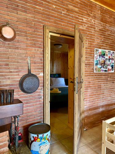 a brick walled room with a door leading to a bedroom at Chalet Natura la taverna dei 3 porcellini in Cavaliere