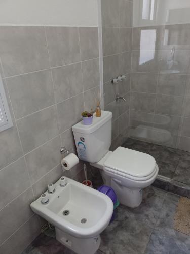 a bathroom with a toilet and a sink at Cabañas Cafayate in Cafayate