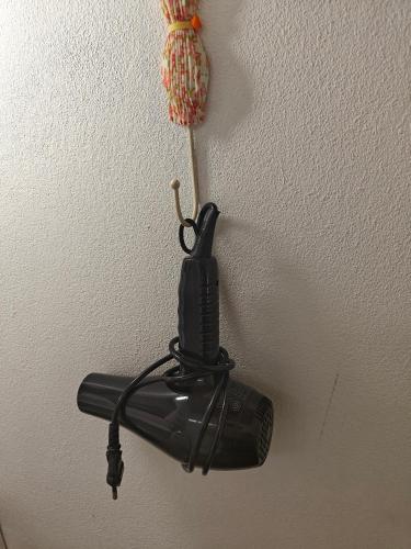 a black phone hanging on a wall at PMee Home in Ban Nong Hoi