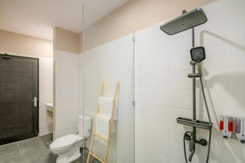 a bathroom with a toilet and a shower at Villa Kisaraa - Kerobokan x Seminyak x Canggu in Kerobokan