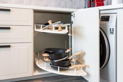 a stack of hats in a microwave oven at Modern & Spacious 2-Bed Condo with Panoramic Lake Views, Dual Balconies, Steps from Dubai JLT Metro By "La Buena Vida Holiday Homes" in Dubai