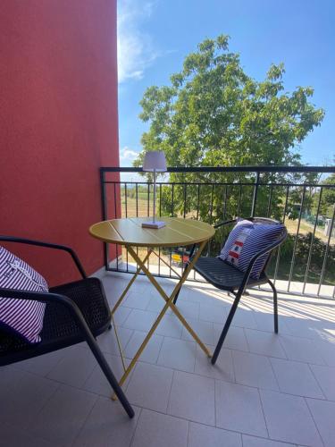 a table and two chairs on a balcony at Sala dell Estate Guest House in Secchia
