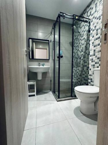 a bathroom with a shower and a toilet and a sink at Martil Costa-Mar in Martil