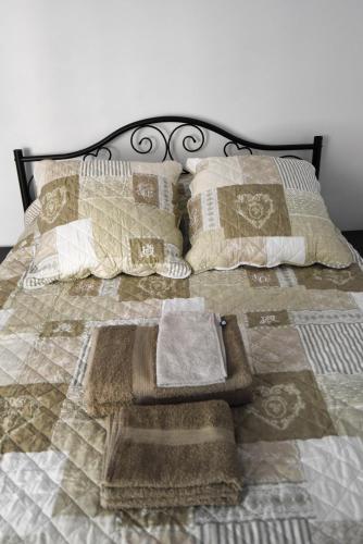 a bed with towels and pillows on it at Les Chambres du Clavero in Claviers