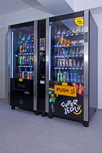 two soda vending machines in a room with drinks at Aviator Garni Hotel Bratislava in Bratislava