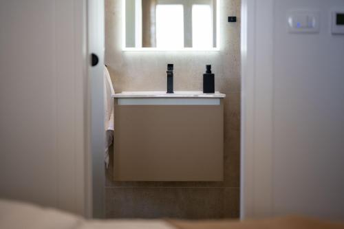 a bathroom with a sink and a window at Lush Suites in Trogir