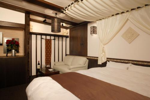 Ένα ή περισσότερα κρεβάτια σε δωμάτιο στο HOTEL K's ABA Adult Only