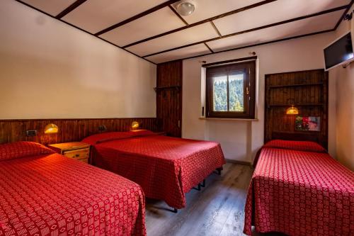 Cama ou camas em um quarto em Hotel Saint Nicolas Gran Paradiso
