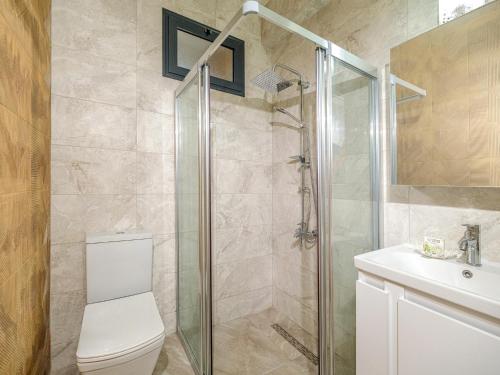 a bathroom with a shower and a toilet and a sink at Starlight Terrace PENTHOUSE in Marmara