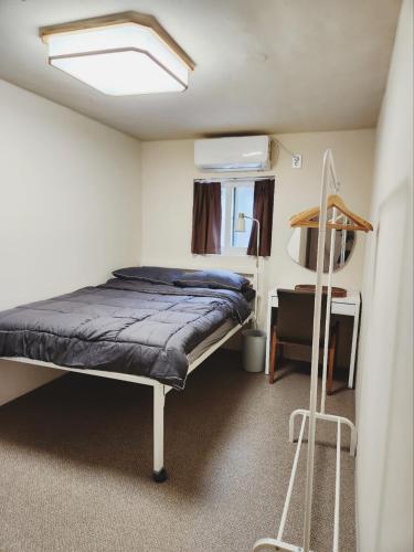 a bedroom with a bed and a chair in a room at Zen Seoul Stay in Seoul