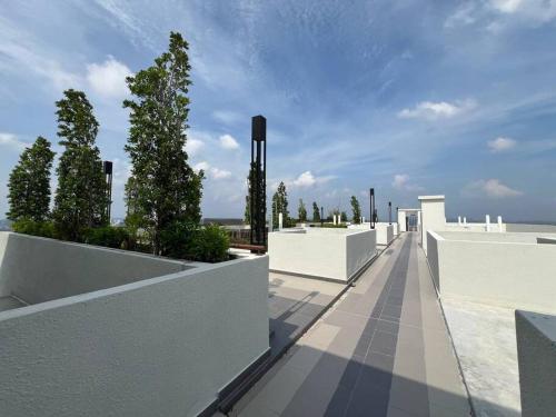 a building with white walls and trees on it at Fify Homestay in Putrajaya